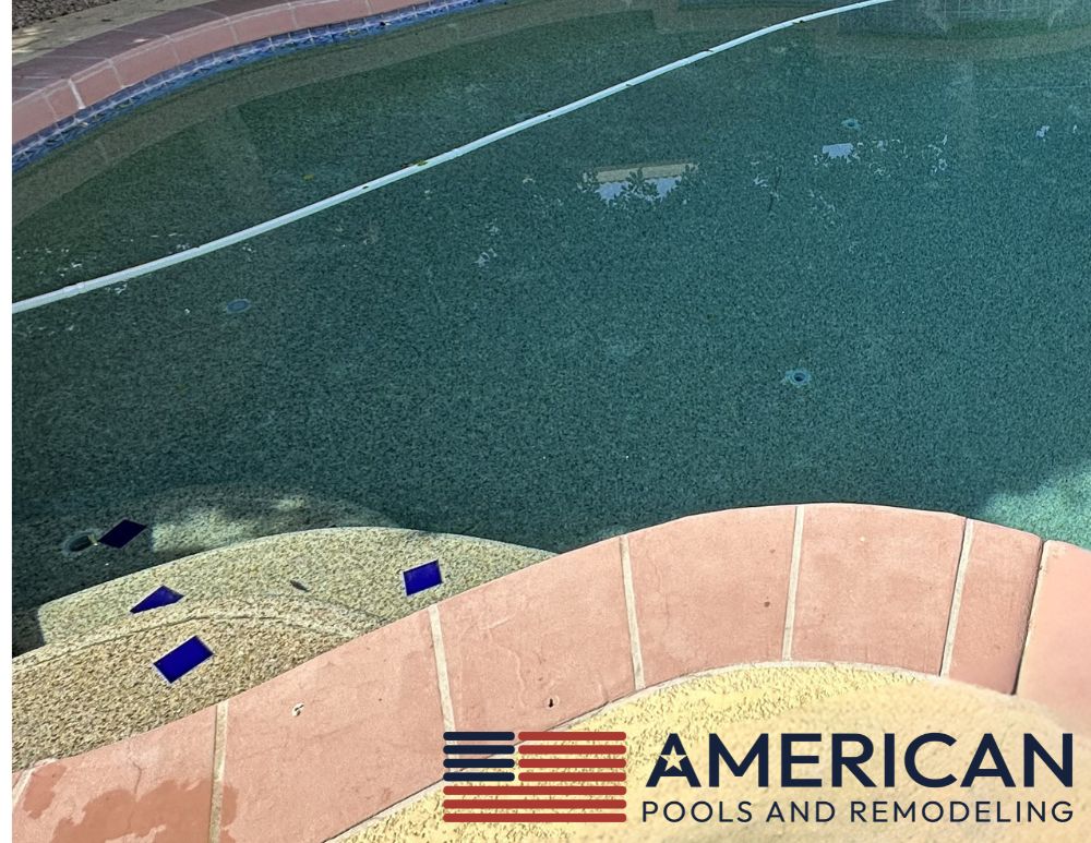 Older Arizona pool with traditional tile, green pebble finish, and aging cool deck