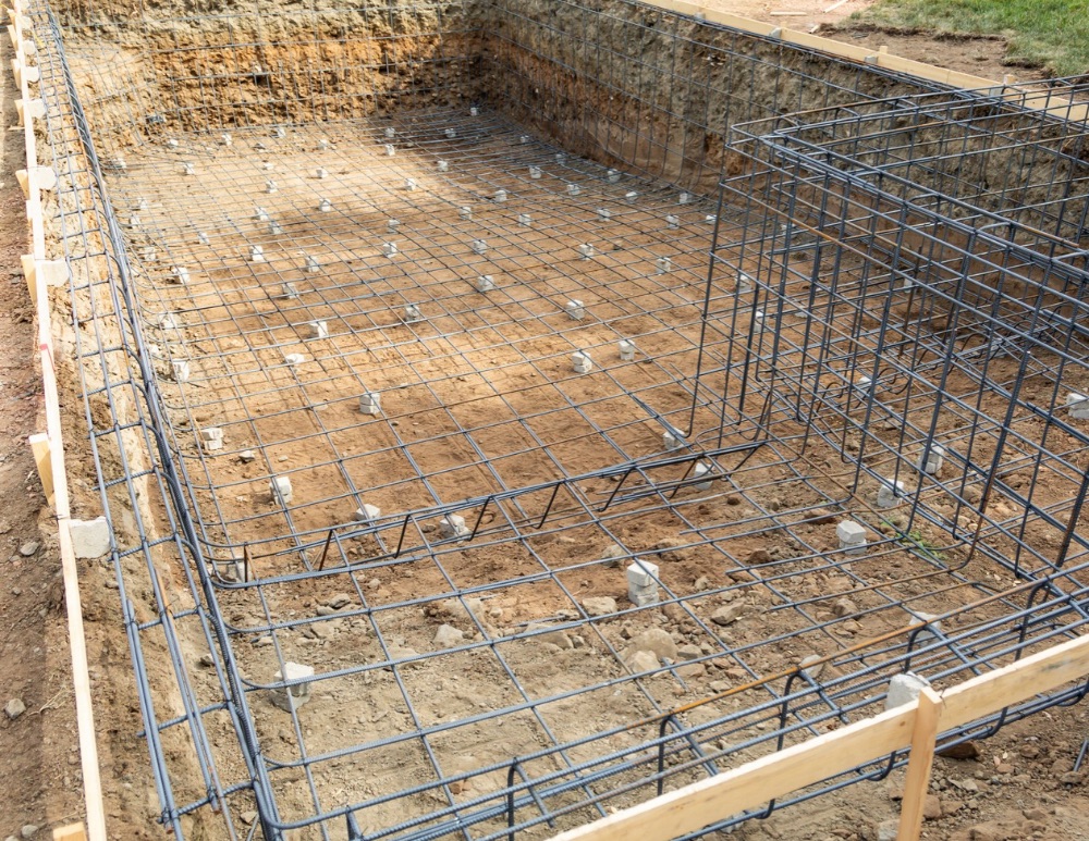 Custom swimming pool under construction with structural steel in place