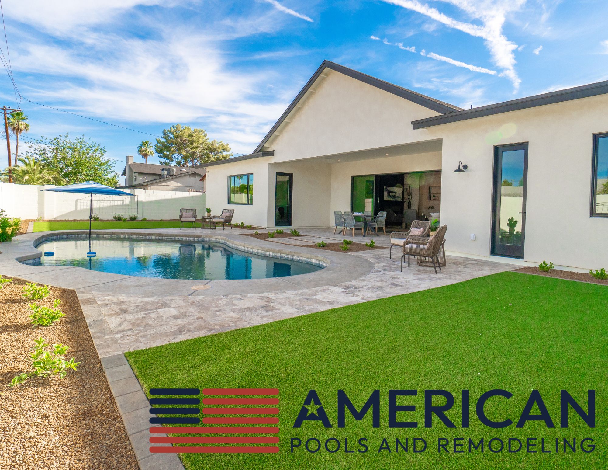 Remodeled Arizona backyard pool with updated decking and desert landscaping